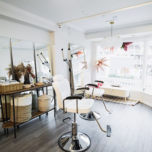 The image shows a modern, bright hair salon with styling chairs, a large mirror, and wicker storage baskets. There's also natural light from a large window.