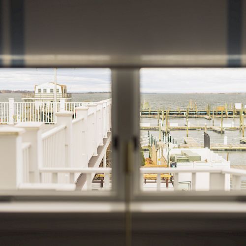 The image shows a view through a window of a waterfront area with docks and piers, overlooking a body of water.