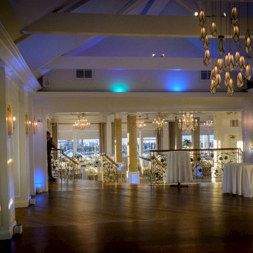 A well-lit modern food court or dining hall with seating, tables, and decorative lighting overhead. End with a period.