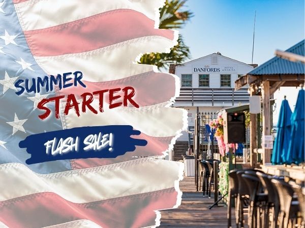 A sunny outdoor scene with a patriotic splash graphic reading &ldquo;Summer Starter&rdquo; and &ldquo;Flash Sale,&rdquo; near a pavilion and seating by the water.